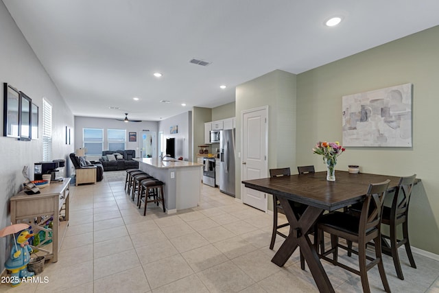 dining space featuring light tile patterned floors, recessed lighting, a ceiling fan, baseboards, and visible vents