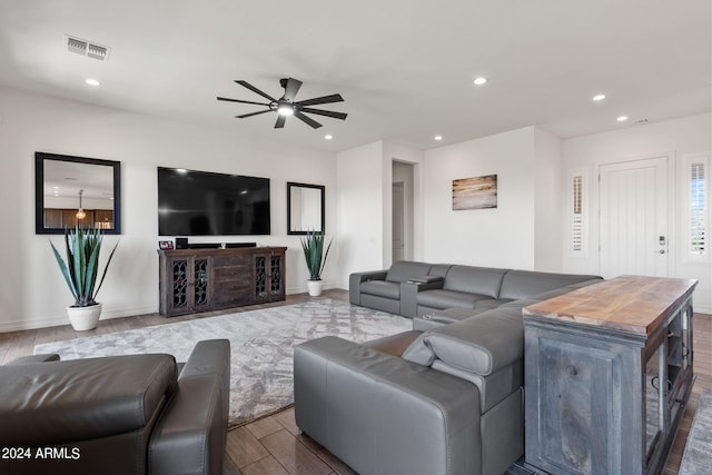 living room with wood-type flooring and ceiling fan