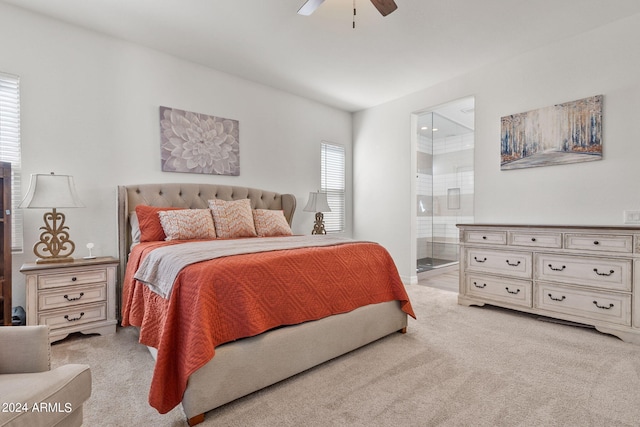 bedroom featuring light colored carpet, connected bathroom, and ceiling fan