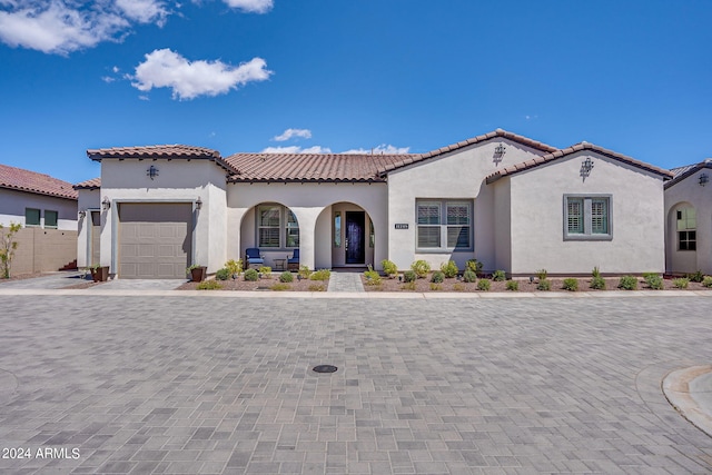 mediterranean / spanish-style house with a garage