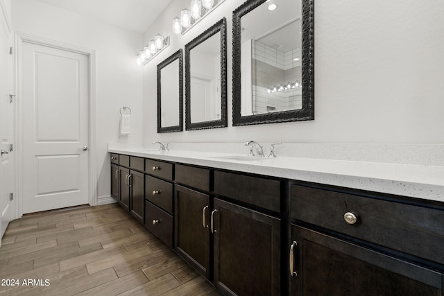 bathroom with wood-type flooring and dual vanity