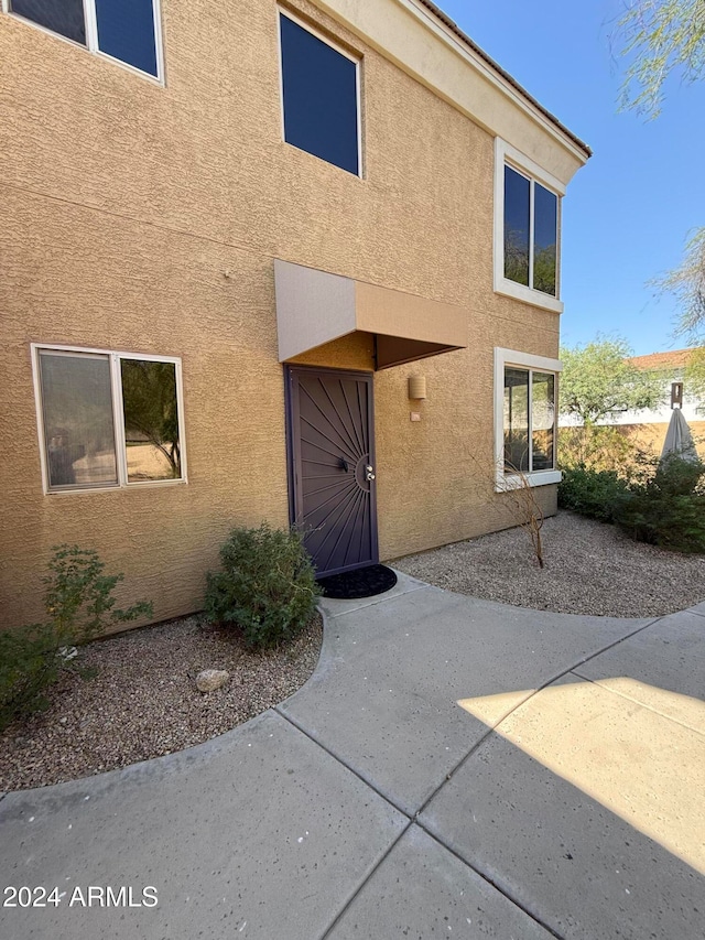 doorway to property with a patio area