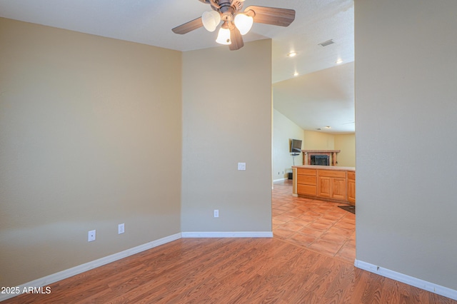 unfurnished room featuring light hardwood / wood-style flooring and ceiling fan