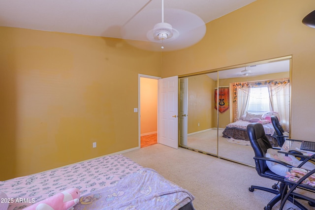 bedroom featuring a closet, ceiling fan, a high ceiling, and carpet floors