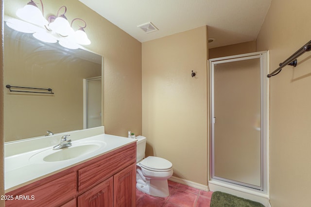 bathroom with vanity, a shower with shower door, tile patterned floors, and toilet