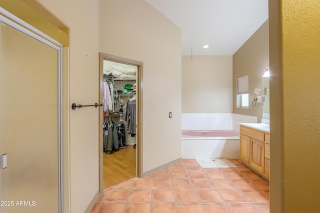 bathroom featuring tile patterned floors, vanity, and independent shower and bath