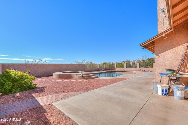 view of pool featuring an in ground hot tub and a patio