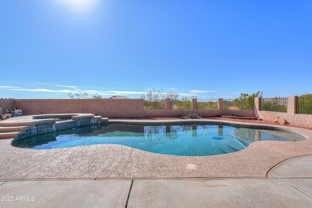 view of pool with an in ground hot tub and a patio