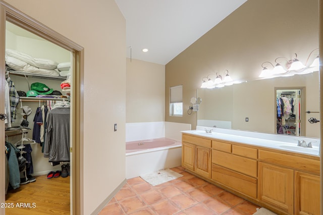 bathroom with vanity, a bathing tub, and tile patterned flooring