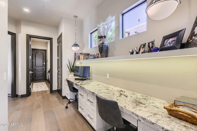 office with light wood-style floors, recessed lighting, built in study area, and baseboards