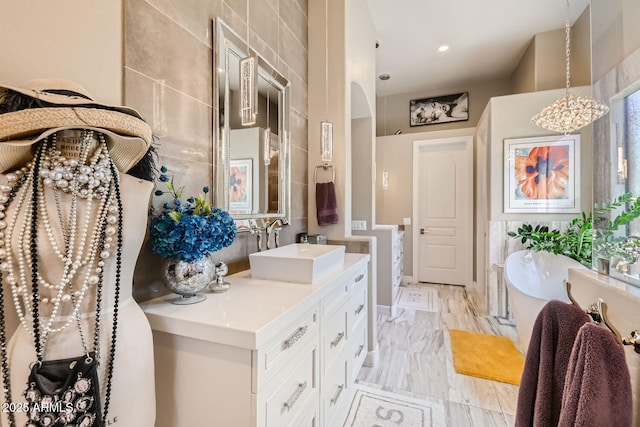 bathroom with a freestanding tub and vanity