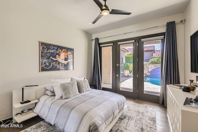 bedroom with access to outside, a ceiling fan, wood finished floors, and french doors