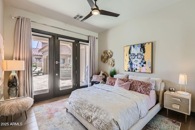 bedroom featuring access to outside, french doors, visible vents, and wood finished floors