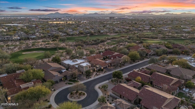 aerial view at dusk featuring a residential view and a mountain view