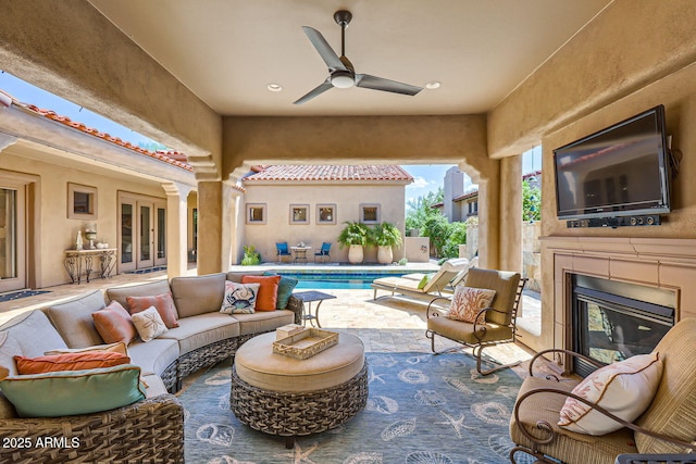 view of patio featuring an outdoor living space with a fireplace, a fenced in pool, and a ceiling fan