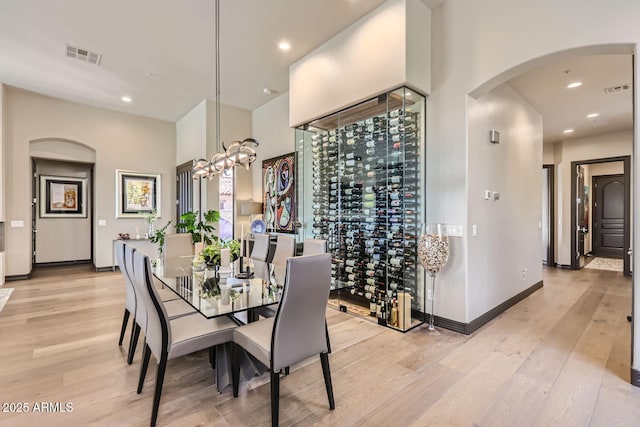 dining space with light wood finished floors, baseboards, visible vents, and recessed lighting