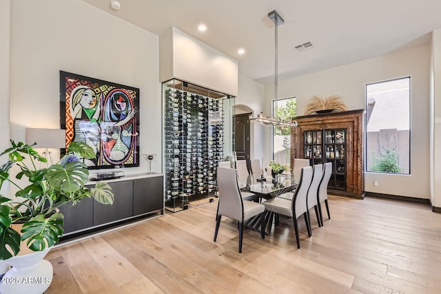 dining room with light wood finished floors, visible vents, and recessed lighting