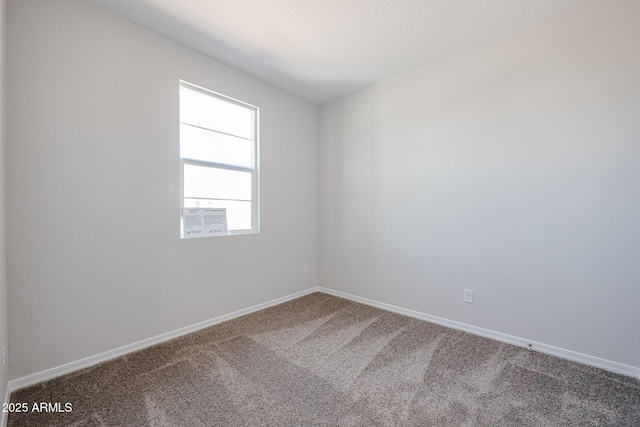 unfurnished room featuring baseboards and carpet floors