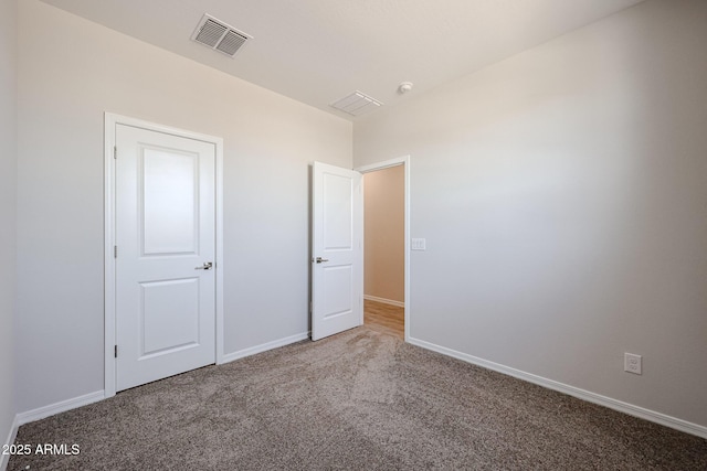 unfurnished bedroom featuring baseboards, visible vents, and carpet floors