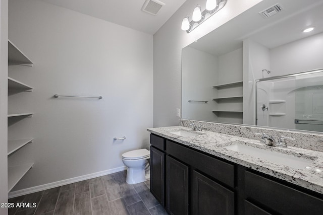 full bathroom featuring walk in shower, visible vents, a sink, and toilet
