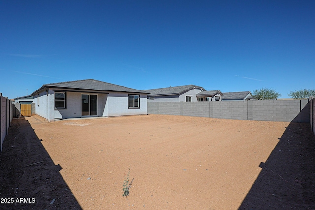 back of house featuring a fenced backyard