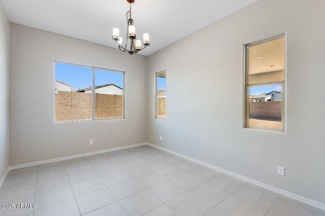 empty room featuring a notable chandelier