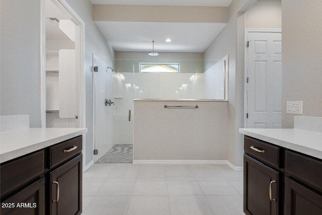 bathroom featuring vanity and a shower with door