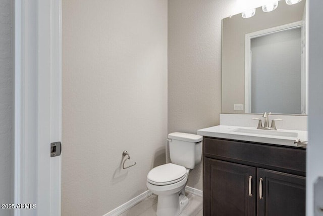 bathroom with vanity, tile patterned flooring, and toilet