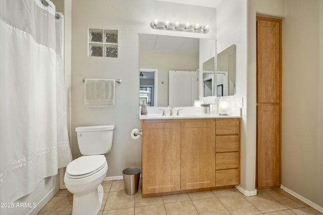 full bath with tile patterned floors, toilet, vanity, and baseboards