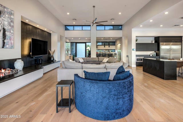 9148 N 66th Pl, Paradise Valley, AZ 85253 - living area featuring light wood-style floors, a ceiling fan, and recessed lighting