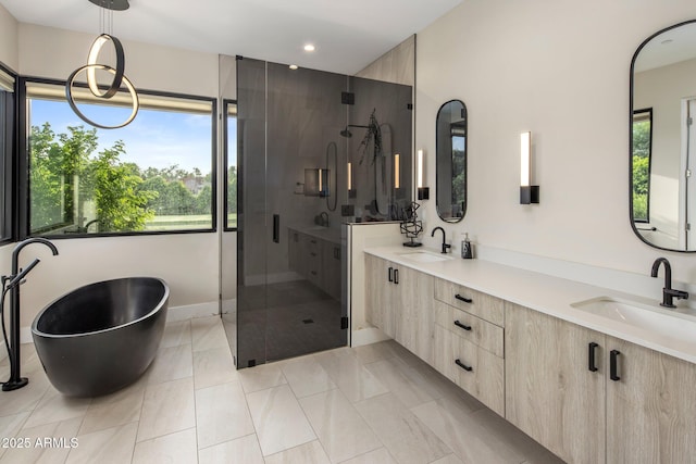 9148 N 66th Pl, Paradise Valley, AZ 85253 - bathroom with a stall shower, double vanity, a soaking tub, recessed lighting, and baseboards