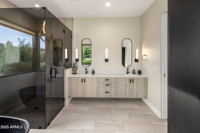 9148 N 66th Pl, Paradise Valley, AZ 85253 - bathroom with double vanity, a shower stall, recessed lighting, baseboards, and a soaking tub