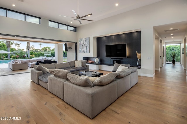 9148 N 66th Pl, Paradise Valley, AZ 85253 - living room featuring light wood-style flooring, a high ceiling, ceiling fan, recessed lighting, and baseboards