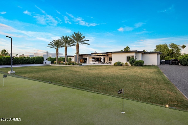 9148 N 66th Pl, Paradise Valley, AZ 85253 - view of front of property featuring a putting area, stucco siding, and a front lawn