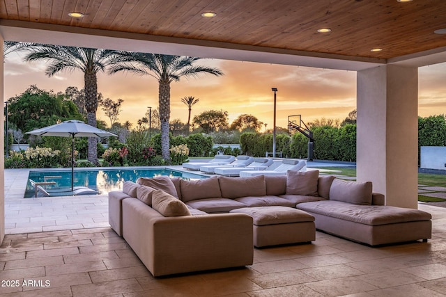9148 N 66th Pl, Paradise Valley, AZ 85253 - patio terrace at dusk with an outdoor hangout area, an outdoor pool, and a patio area