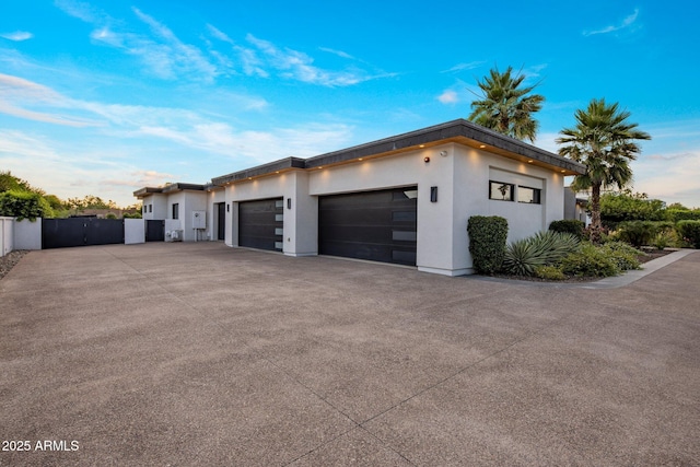 9148 N 66th Pl, Paradise Valley, AZ 85253 - view of side of home featuring concrete driveway, a garage, and stucco siding