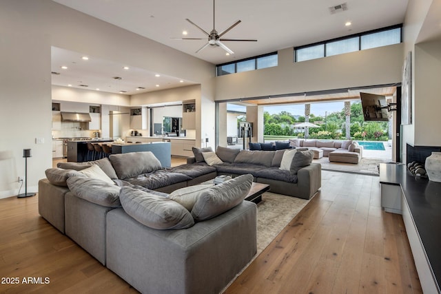 9148 N 66th Pl, Paradise Valley, AZ 85253 - living area featuring hardwood / wood-style flooring, ceiling fan, a high ceiling, and recessed lighting