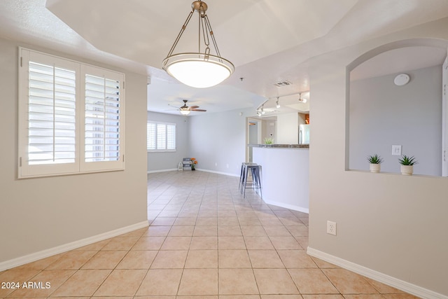 spare room featuring ceiling fan and light tile patterned floors