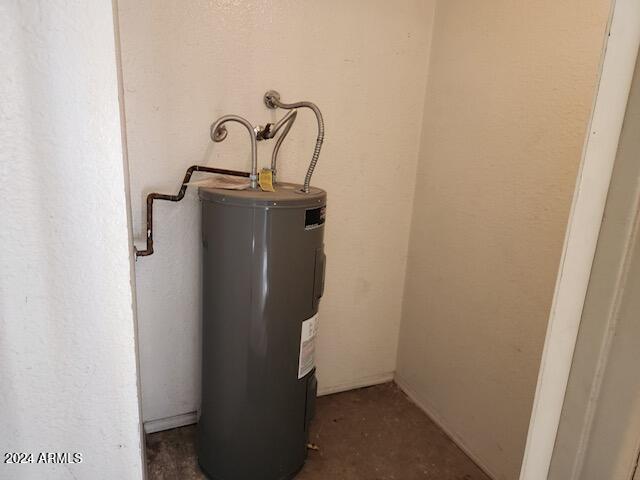 utility room featuring electric water heater