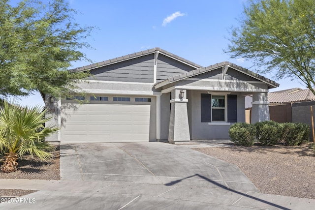 6919 S 13th Pl, Phoenix, AZ 85042 - craftsman house featuring driveway, a garage, a tiled roof, stucco siding, and covered porch