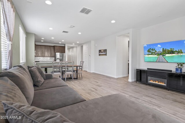 6919 S 13th Pl, Phoenix, AZ 85042 - living room with light wood-style floors and recessed lighting