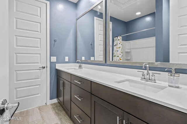 6919 S 13th Pl, Phoenix, AZ 85042 - full bath with double vanity, wood finished floors, and a shower with curtain