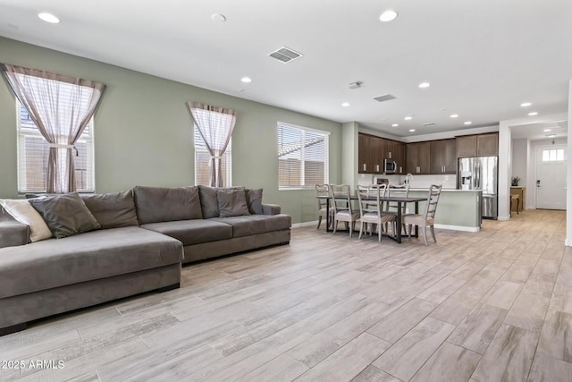 6919 S 13th Pl, Phoenix, AZ 85042 - living room featuring light wood-type flooring and recessed lighting
