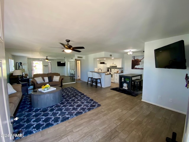 living room with ceiling fan and hardwood / wood-style floors