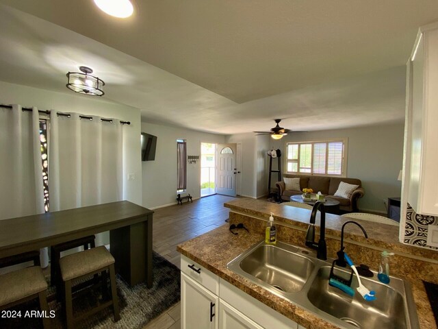 kitchen featuring ceiling fan, sink, dark hardwood / wood-style floors, and white cabinets