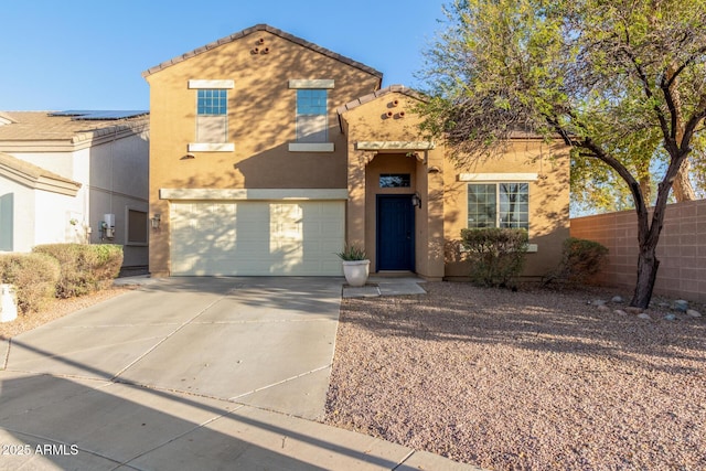 mediterranean / spanish house with fence, a tiled roof, stucco siding, a garage, and driveway