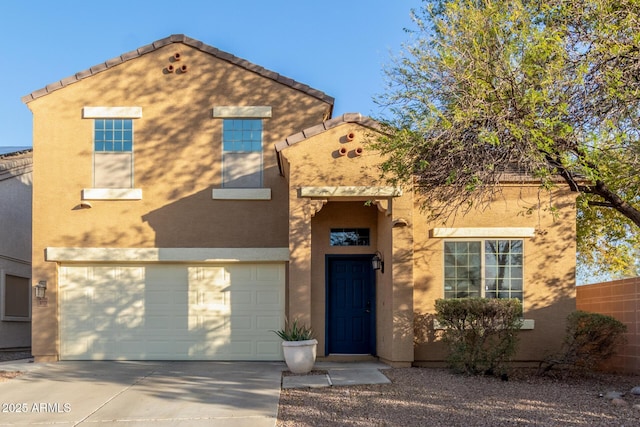 view of front of home with stucco siding, a garage, concrete driveway, and a tile roof