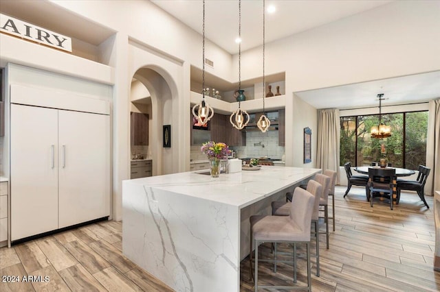 kitchen featuring pendant lighting, light hardwood / wood-style floors, and a kitchen island