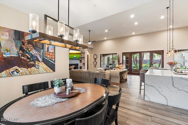 dining room with french doors and light hardwood / wood-style flooring