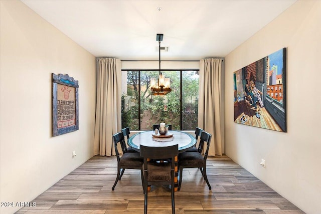 dining room featuring light hardwood / wood-style flooring and a chandelier